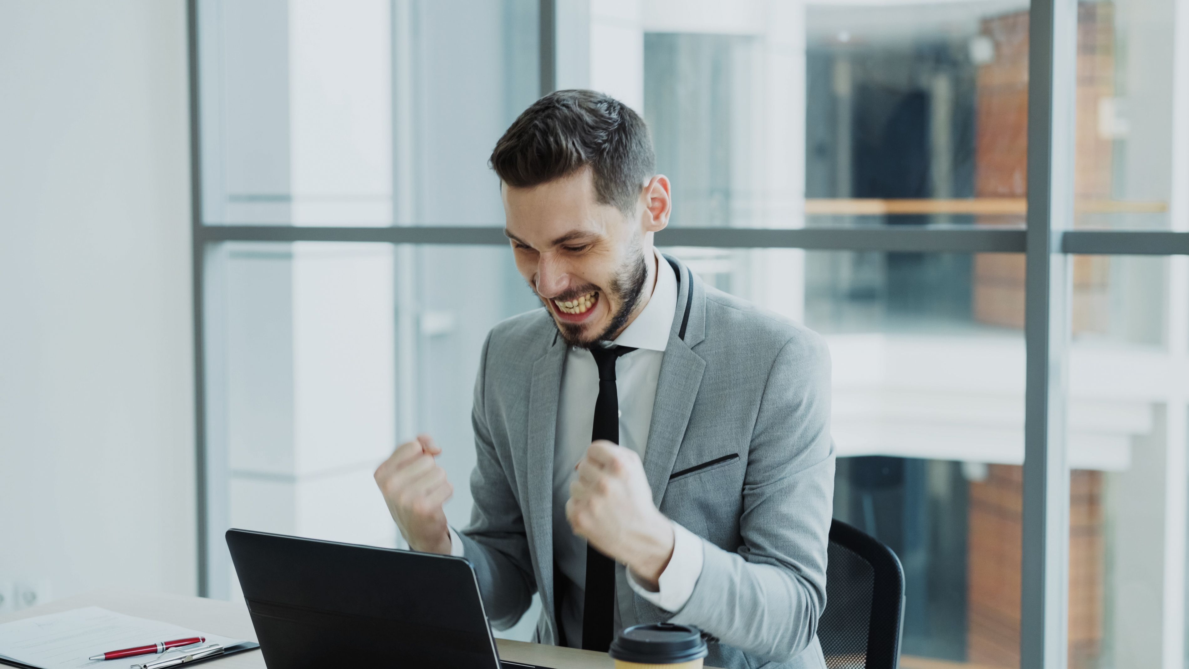 Professional celebrating a job offer after Search & Apply support
